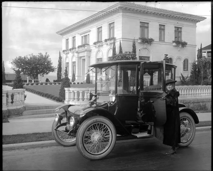 Seattle Sunday Times'ın 1917'de yayımladığı tanıtım fotoğrafında bir kadın, Detroit Electric otomobilinin yanında poz veriyor